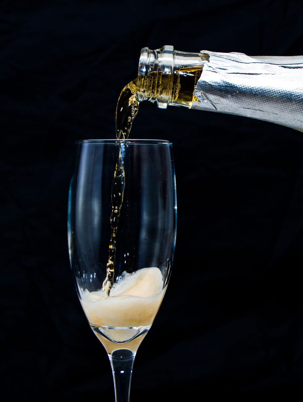 close up shot of champagne pouring in the glass